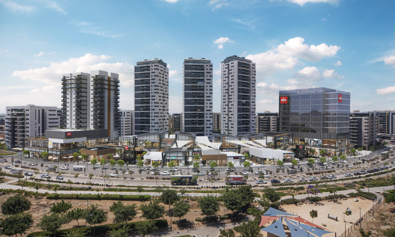 The Carmei Gat neighborhood — BIG center, residential towers, and the surrounding park